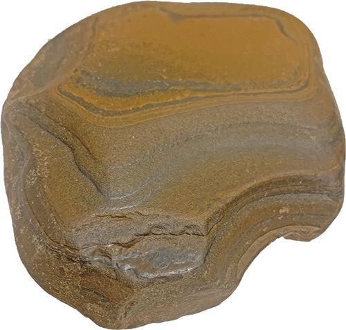 Photo description: A roundish brown stone of many layers, gouged and worn smooth by time and water.